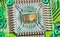 Closeup of electronic integrated circuit die with photodiode array and gold wires on green PCB