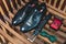 Closeup of elegant stylish black male accessories isolated on yellow wooden planks. High angle view of belt, shoes, cufflinks and