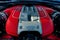 Closeup of the engine bay of a red Ferrari car.