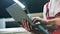 Closeup of engineer hands typing on laptop at metal factory