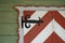 Closeup of an entrance door painted white and red on the house deck