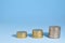 Closeup of euro coins stacked in ascending order on blue background