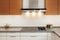 Closeup of exhaust hood and ceramic cooking plate in the new modern kitchen.