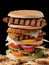 Closeup of extra tall hamburger with delicious ingredients