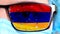 Closeup, eye, part of doctor face in medical mask, glasses, which painted in colors of Armenia flag. Many viruses, germs