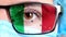 Closeup, eye, part of doctor face in medical mask, glasses, which painted in colors of Italy flag. Many viruses, germs