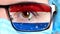 Closeup, eye, part of doctor face in medical mask, glasses, which painted in colors of Paraguay flag. Many viruses