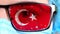 Closeup, eye, part of doctor face in medical mask, glasses, which painted in colors of Turkey flag. Many viruses, germs