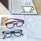 closeup eyeglasses, coffee cup icon and laptop on report graph o