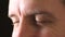 Closeup eyes of a man staring and blinking while looking focused, thinking of ideas. Man with blurry vision trying to