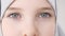 Closeup eyes of muslim teen girl in hijab looking at camera.