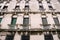 Closeup of the facade of a building, on the streets of Venice, Italy. White stone building with classic arched Venetian