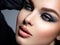Closeup face of a beautiful girl with makeup in style smoky eye