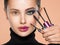 Closeup face of a beautiful white woman with  brushes for mascara. Portrait of a girl with cosmetic brushes near face. Woman