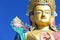 Closeup face of giant Maitreya Buddha statue with blue sky with space.