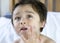 Closeup face of little boy applying body lotion cream on his cheek after shower,Kid using cream for skincare protection,Child mois