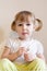 Closeup face portrait of funny two years old blonde white girl