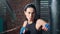 Closeup face of strong fitness lady showing beating boxing in gloves at box studio slowmo