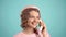 Closeup face of young woman pretty surprised pinup girl talking on cell phone. Retro vintage pinup style. Call center
