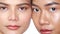 Closeup faces of two beautiful Asian women looking at the camera over white background