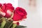 Closeup fake red rose flowers on blurred room view background