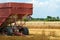 Closeup farm trailer in wheat field