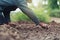 closeup farmer hand planting onion in garden