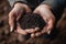 Closeup of Farmer holding fertilizer soil in the agricultural field.