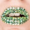 Closeup of Fashion Green Sexy Lips with green and gold gems on lips. Open Mouth. Make up, cosmetics, lip art