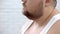 Closeup of fat bearded man in white shirt, obesity problems, lack of self-care