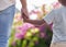 Closeup father and son holding hands while walking outside in the garden. A great role model and mentor for his boy