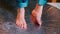 A closeup of the feet of a boy doing foot movements.