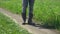 Closeup of feet. the man in canvas boots coming down the road in the field