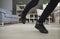 Closeup of feet of a person who trips over an electric cord at home or in the office