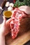 Closeup of female butcher`s hands holding meat piece