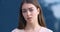 Closeup of female displeased face. Portrait of angry upset bewildered young business woman student standing outdoors at