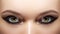 Closeup female eyes with bright make-up, great shapes brows, extreme long eyelashes. Celebrate makeup, luxury eyeshadows