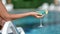 Closeup female hand hold goblet with cocktail relax near swimming pool. Shot with RED camera in 4K