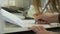 Closeup of a female hand writing on an blank notebook with a pen. Close-up of a female hand writing on an blank notebook