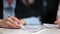 Closeup female hands analyzing reading signing deal agreement at formal business appointment