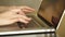 Closeup of a female hands busy typing on a laptop