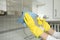 Closeup of female hands in gloves cleaning the extractor hood