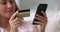 Closeup female hands makes payment use smartphone and credit card