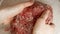 Closeup of female hands mixing and beating minced beef meat before making hamburgers. Cooking at home