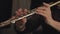 closeup of female hands playing flute in concert theatre orcherstra