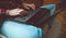 Closeup of female hands typing on laptop computer sitting relaxed at home