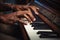 Closeup female male hands talented African-American musician musical teacher playing piano fingers touching piano tiles