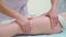 Closeup of female masseur hands doing anti cellulite massage on woman thighs