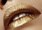 Closeup Female Plump Lips with Gold Color Makeup. Fashion Celebrate Make-up, Glitter Cosmetic. Christmas Style