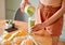 Closeup of a female pouring green healthy smoothie to detox, drinking vitamins and nutrients. Woman nutritionist having